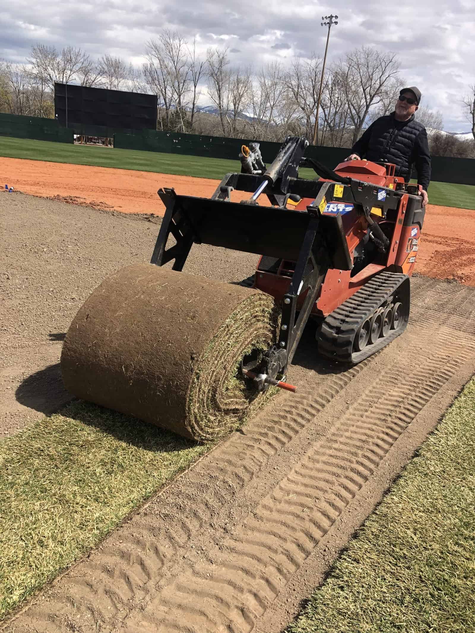 Big roll getting installed on mini skid steer